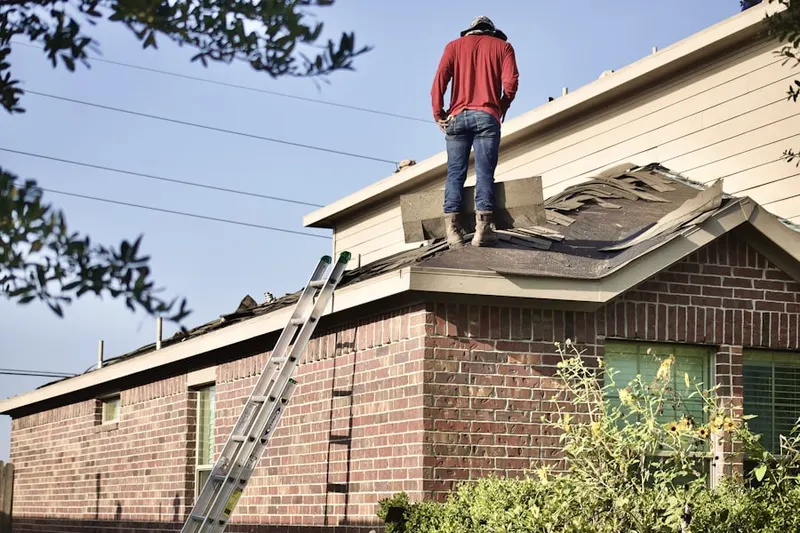 Professional roofer working on a residential roof in Shorewood Park